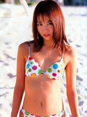 Enjoying her day at the beach in her bikini this asian babe stuns